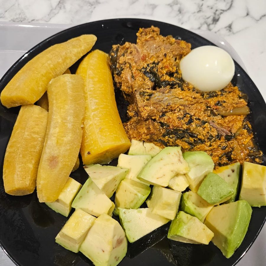 Kontomire stew served with ripe plantain and avocado
